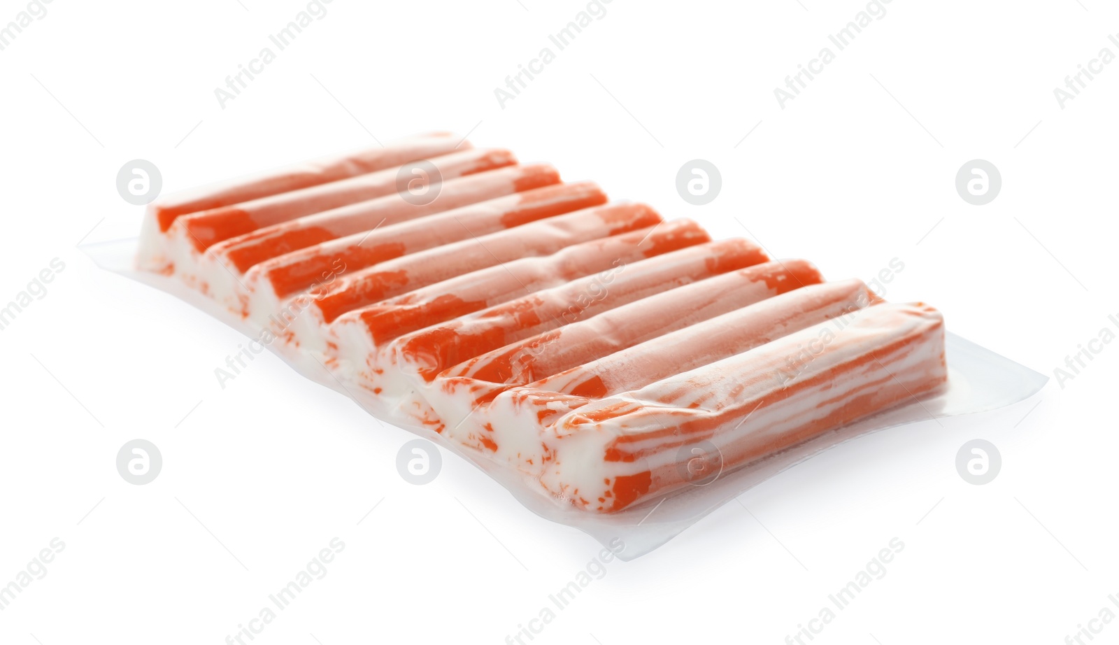 Photo of Delicious crab sticks in plastic packaging isolated on white