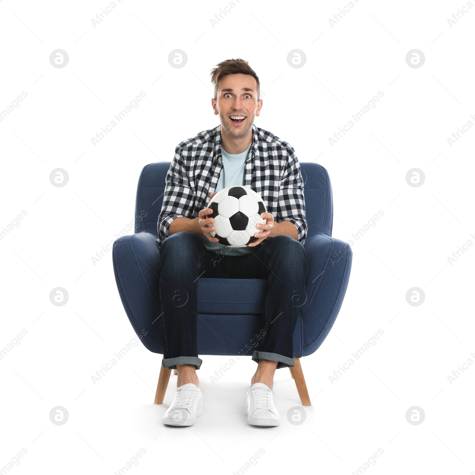 Photo of Handsome young man sitting in armchair and watching soccer match on white background