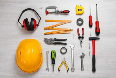 Flat lay composition with different construction tools on light background