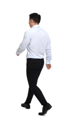 Businessman in formal clothes walking on white background