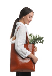 Young woman with leather shopper bag on white background