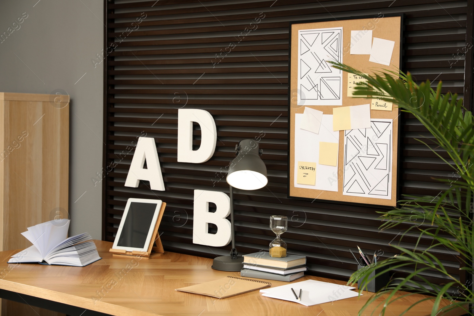 Photo of Comfortable workplace with tablet and wooden table