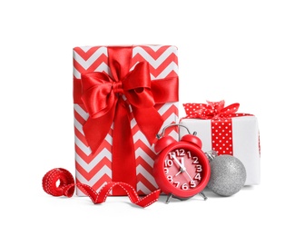 Photo of Beautifully wrapped gift boxes, alarm clock and decorations on white background