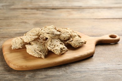 Photo of Dried soya chunks on wooden table. Meat substitute