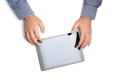 Man with tablet on white background, top view. Closeup of hands