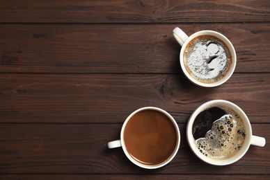 Flat lay composition with cups of coffee on wooden background. Food photography