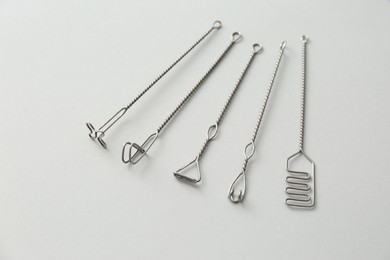 Photo of Set of logopedic probes for speech therapy on light grey background, above view