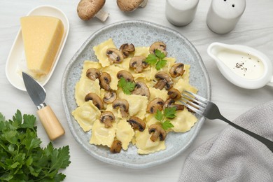 Delicious ravioli with ingredients on white wooden table, flat lay