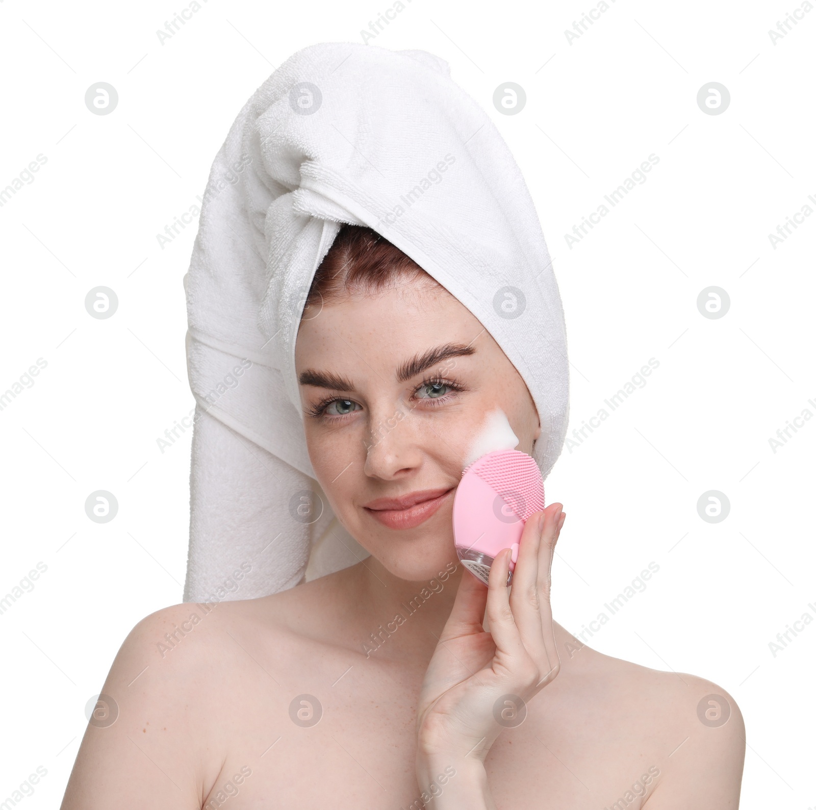 Photo of Young woman washing face with brush and cleansing foam on white background