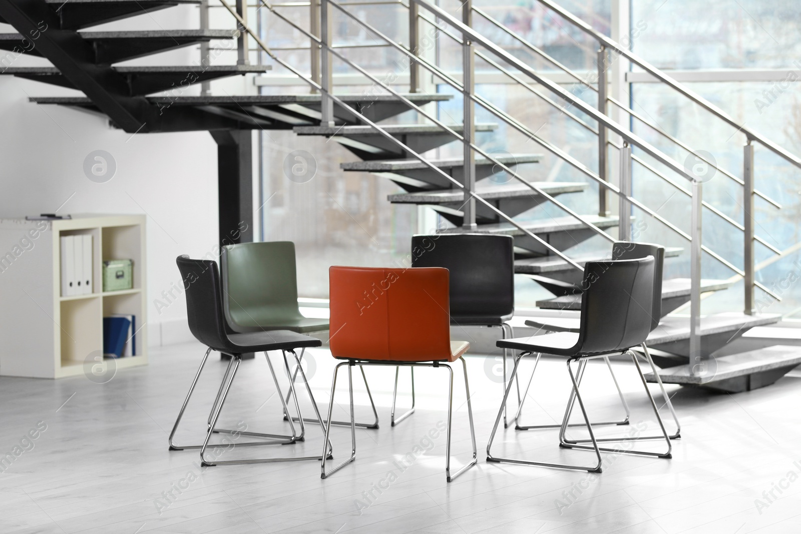 Photo of Chairs prepared for group therapy session in office. Meeting room interior