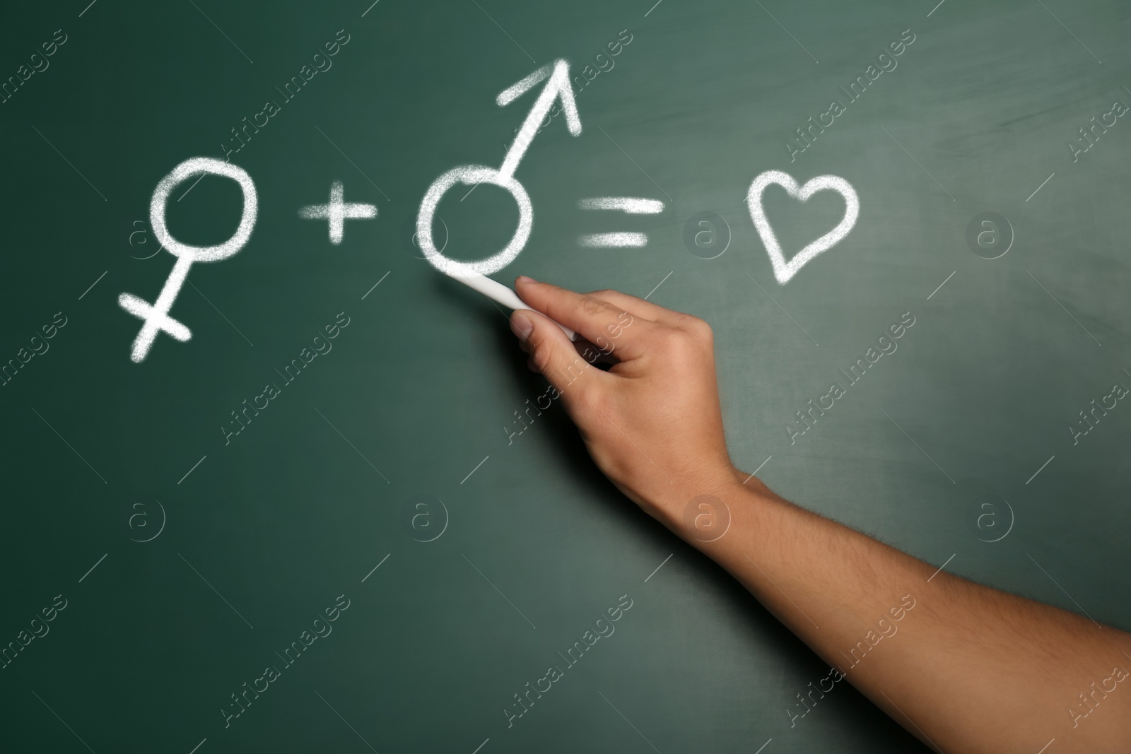 Image of Sex Education. Woman drawing male gender sign in equation on green chalkboard, closeup. Man plus woman equals love