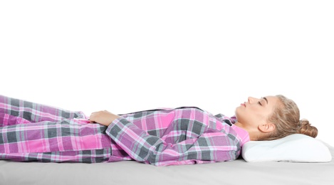 Beautiful woman sleeping with orthopedic pillow on bed against white background