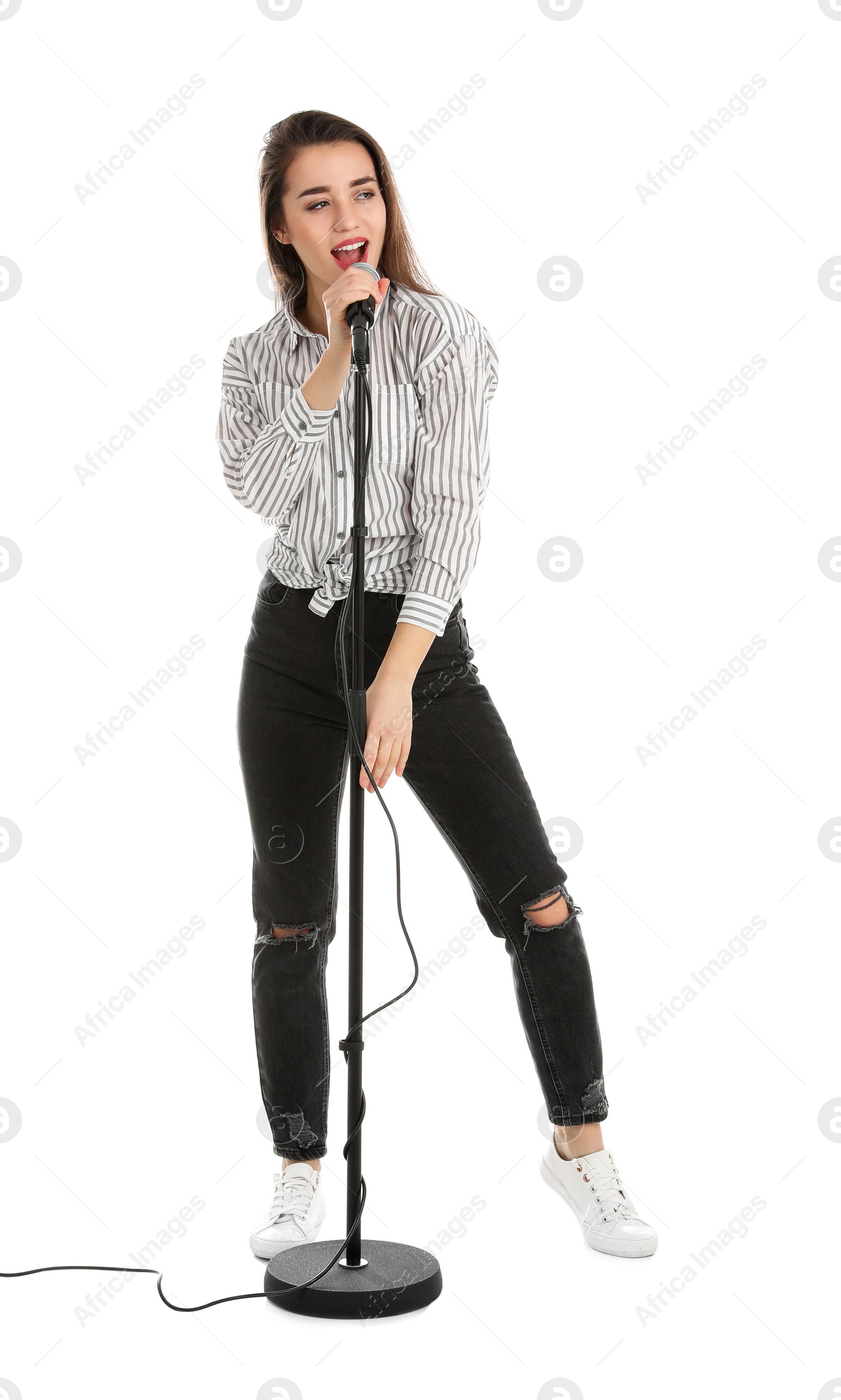 Photo of Young woman wearing casual clothes singing in microphone on white background