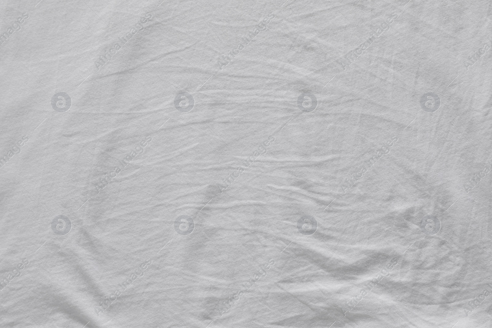 Photo of Crumpled white fabric as background, top view