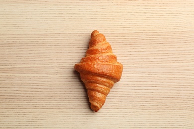 Fresh croissant on wooden background, top view. French pastry