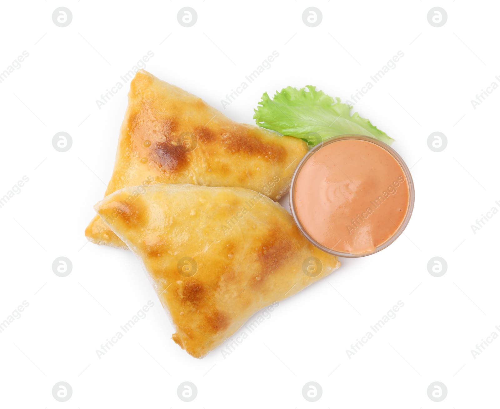 Photo of Delicious samosas, lettuce and sauce isolated on white, top view