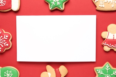 Photo of Flat lay composition with tasty homemade Christmas cookies and blank card on red background. Space for text