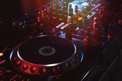 Photo of Closeup view of modern DJ controller on dark background