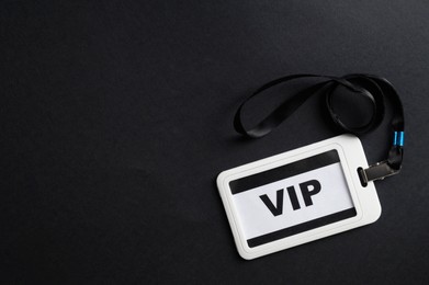 Photo of Plastic vip badge on black background, top view. Space for text