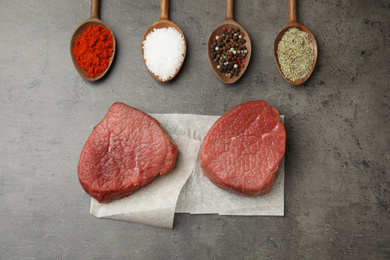 Photo of Flat lay composition with fresh beef cut on grey table