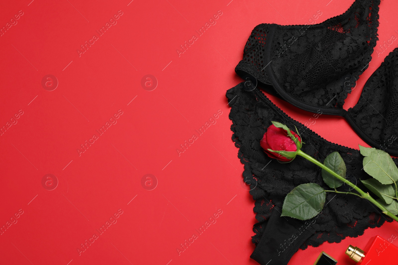 Photo of Flat lay composition with sexy lingerie on red background. Space for text