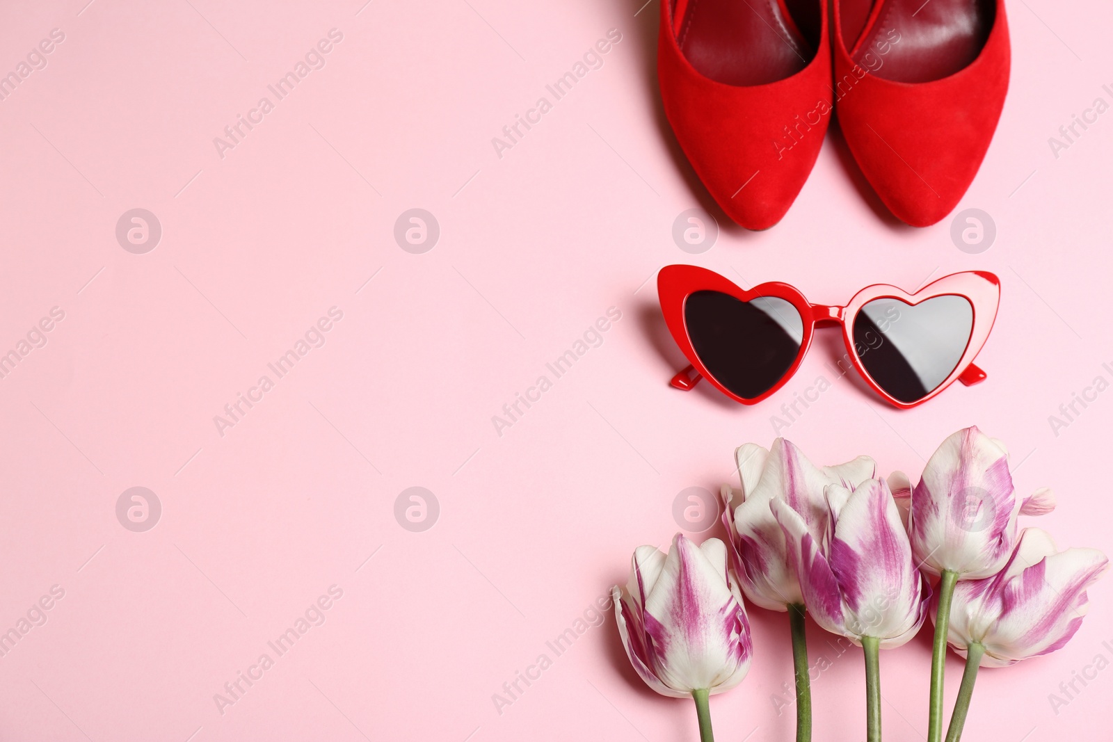 Photo of Flat lay composition with heart shaped sunglasses on color background, space for text