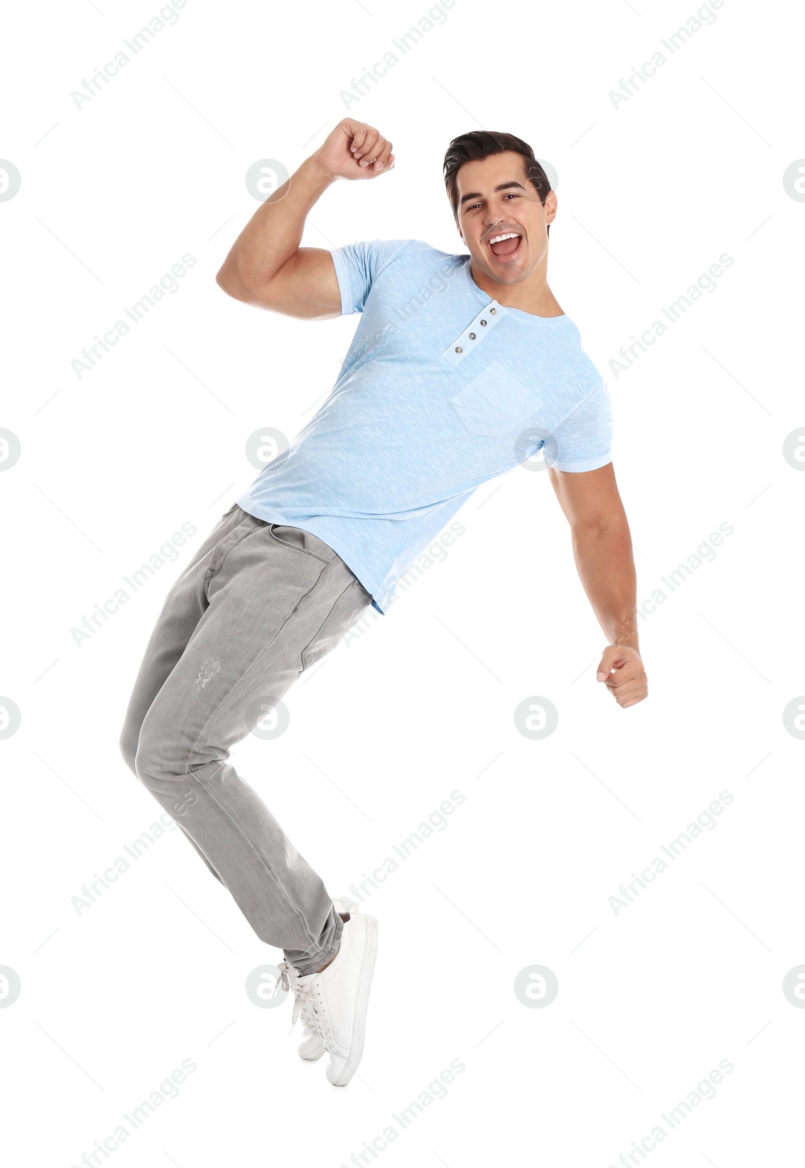 Photo of Handsome young man dancing on white background