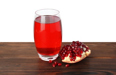 Photo of Refreshing pomegranate juice in glass and seeds on wooden table against white background