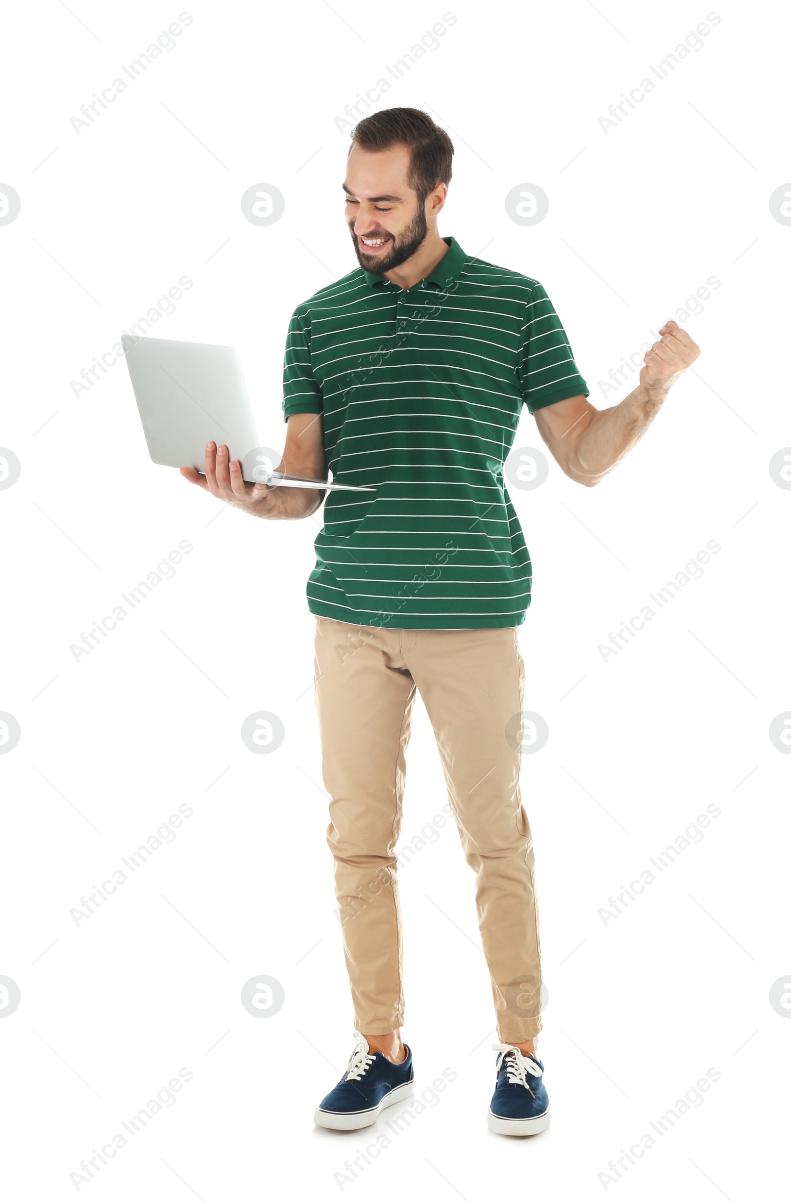 Photo of Emotional young man with laptop celebrating victory on white background