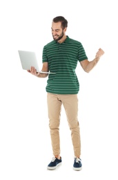 Emotional young man with laptop celebrating victory on white background