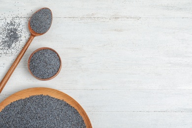 Photo of Flat lay composition with poppy seeds and space for text on white wooden background