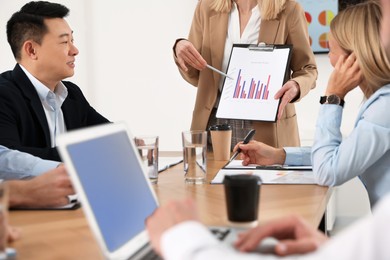 Photo of Businesswoman showing chart on meeting in office, closeup