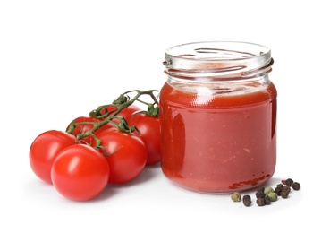 Photo of Jar of sauce and tomatoes isolated on white