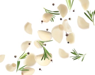 Image of Fresh peeled garlic cloves, peppercorns and rosemary flying on white background