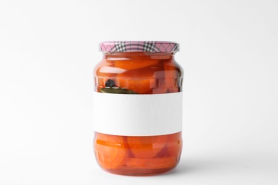 Jar of pickled sliced carrots with blank label on white background