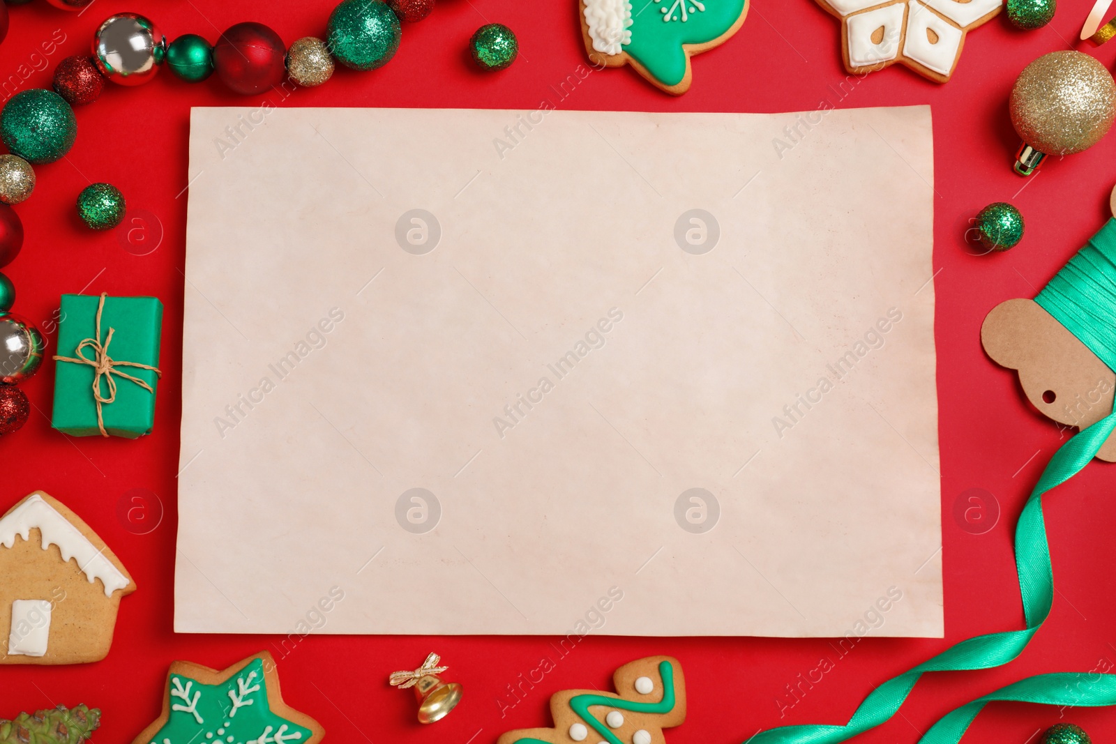 Photo of Blank paper with space for text and Christmas decor on red background, flat lay. Letter to Santa Claus