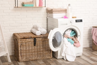 Bathroom interior with dirty towels in washing machine