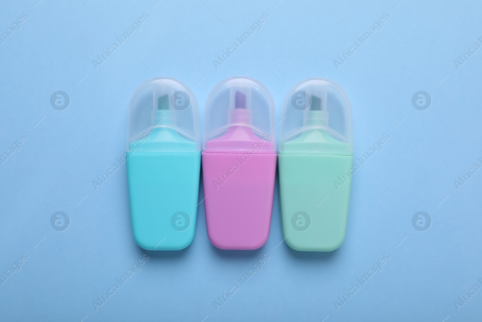 Photo of Colorful markers on light blue background, flat lay