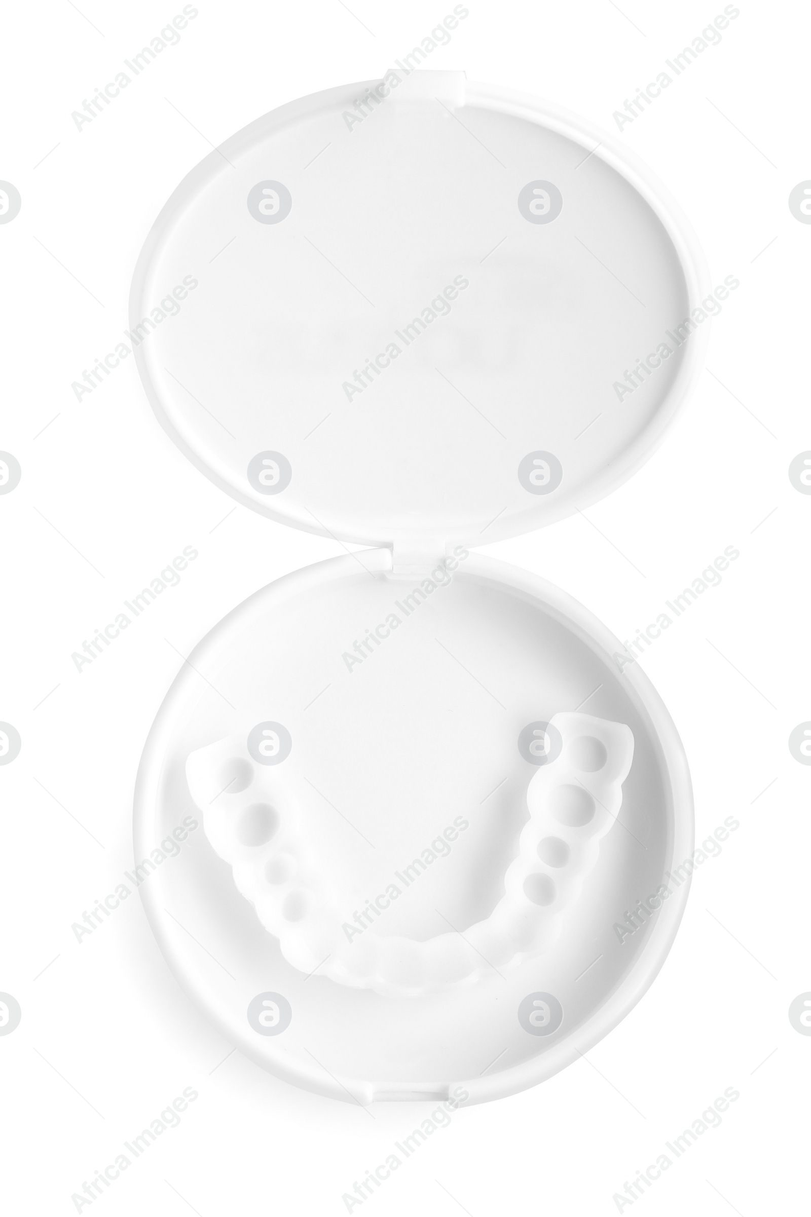 Photo of Dental mouth guard in container on white background, top view. Bite correction