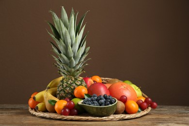 Assortment of fresh exotic fruits on wooden table