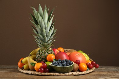 Photo of Assortment of fresh exotic fruits on wooden table