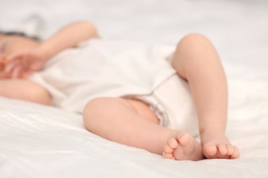Photo of Cute newborn baby sleeping on bed, selective focus