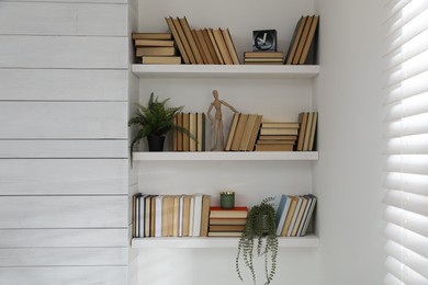 Many shelves with different decor in room. Interior design