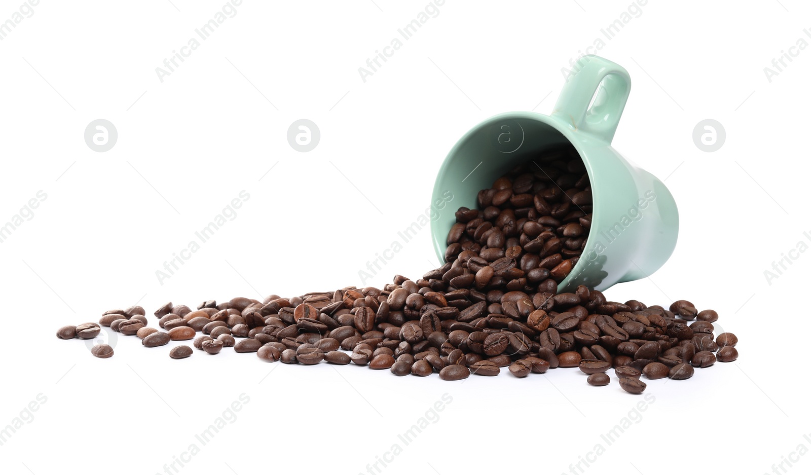 Photo of Coffee beans and overturned cup isolated on white