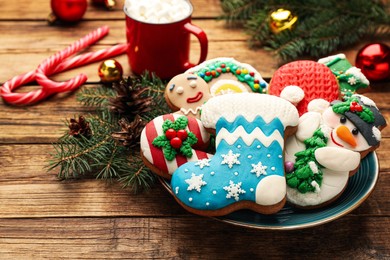 Photo of Delicious homemade Christmas cookies and festive decor on wooden table