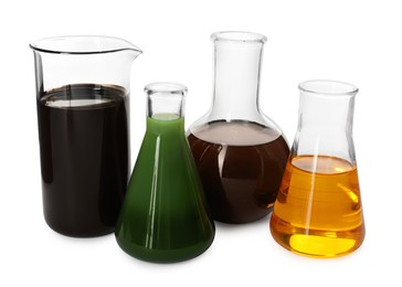 Photo of Beaker and flasks with different types of oil isolated on white