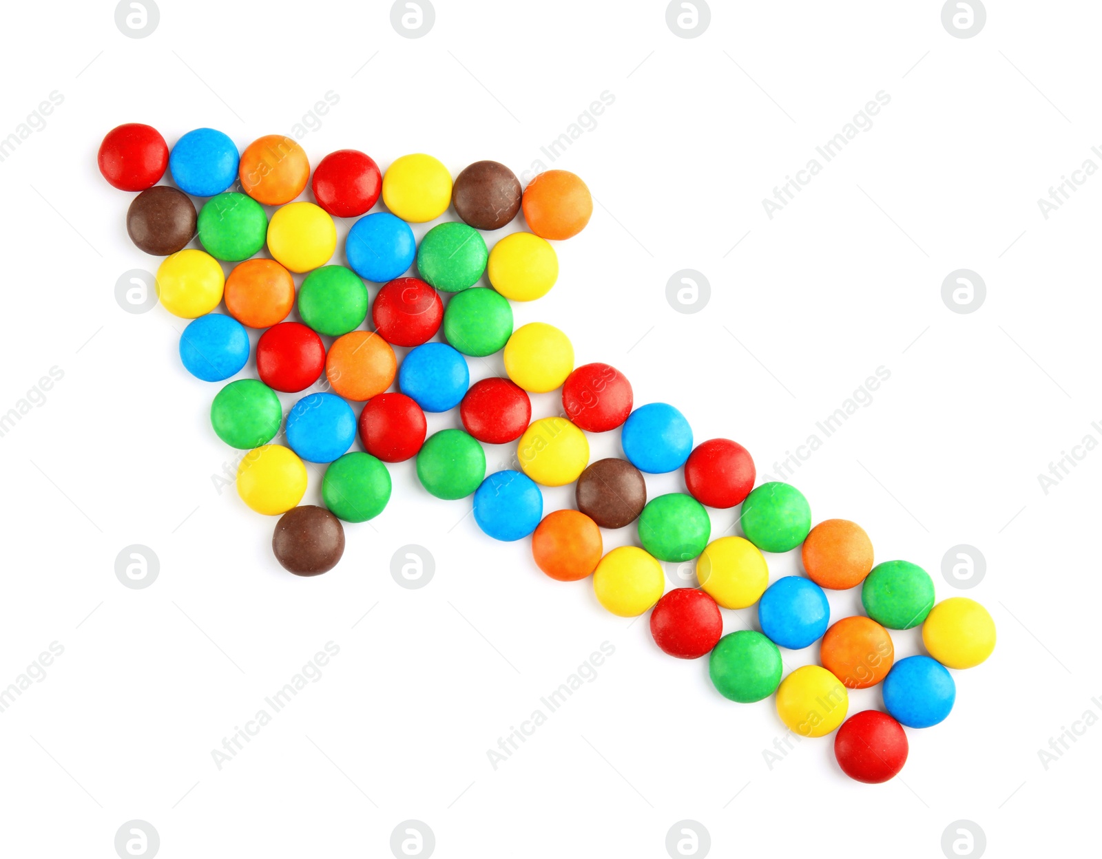 Photo of Arrow made of colorful candies on white background, top view