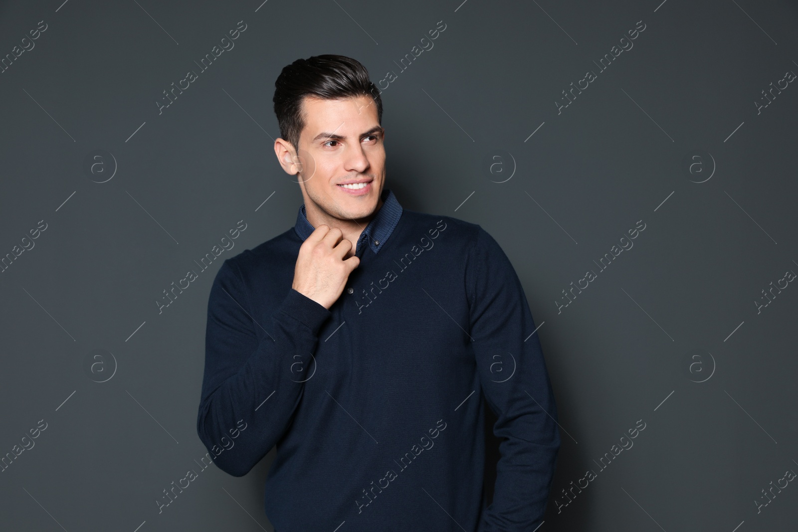 Photo of Portrait of handsome man smiling on grey background