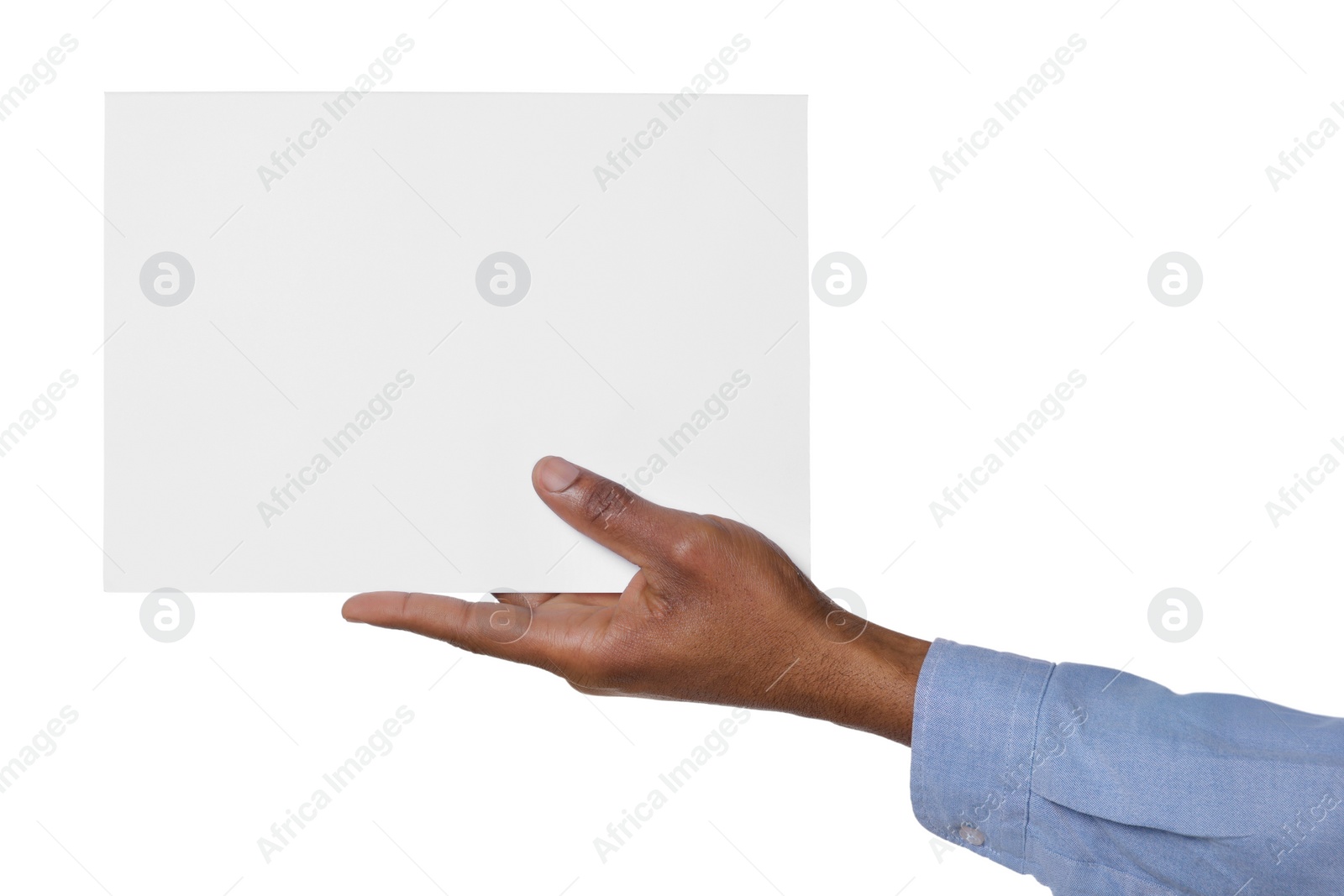 Photo of African American man holding sheet of paper on white background, closeup. Mockup for design