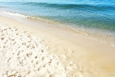 Sandy beach near sea on sunny day